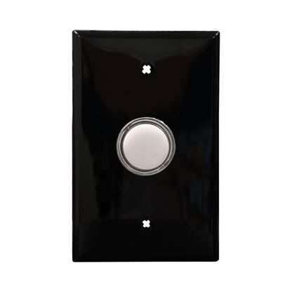 Black wall plate with a white pilot light on a white background.